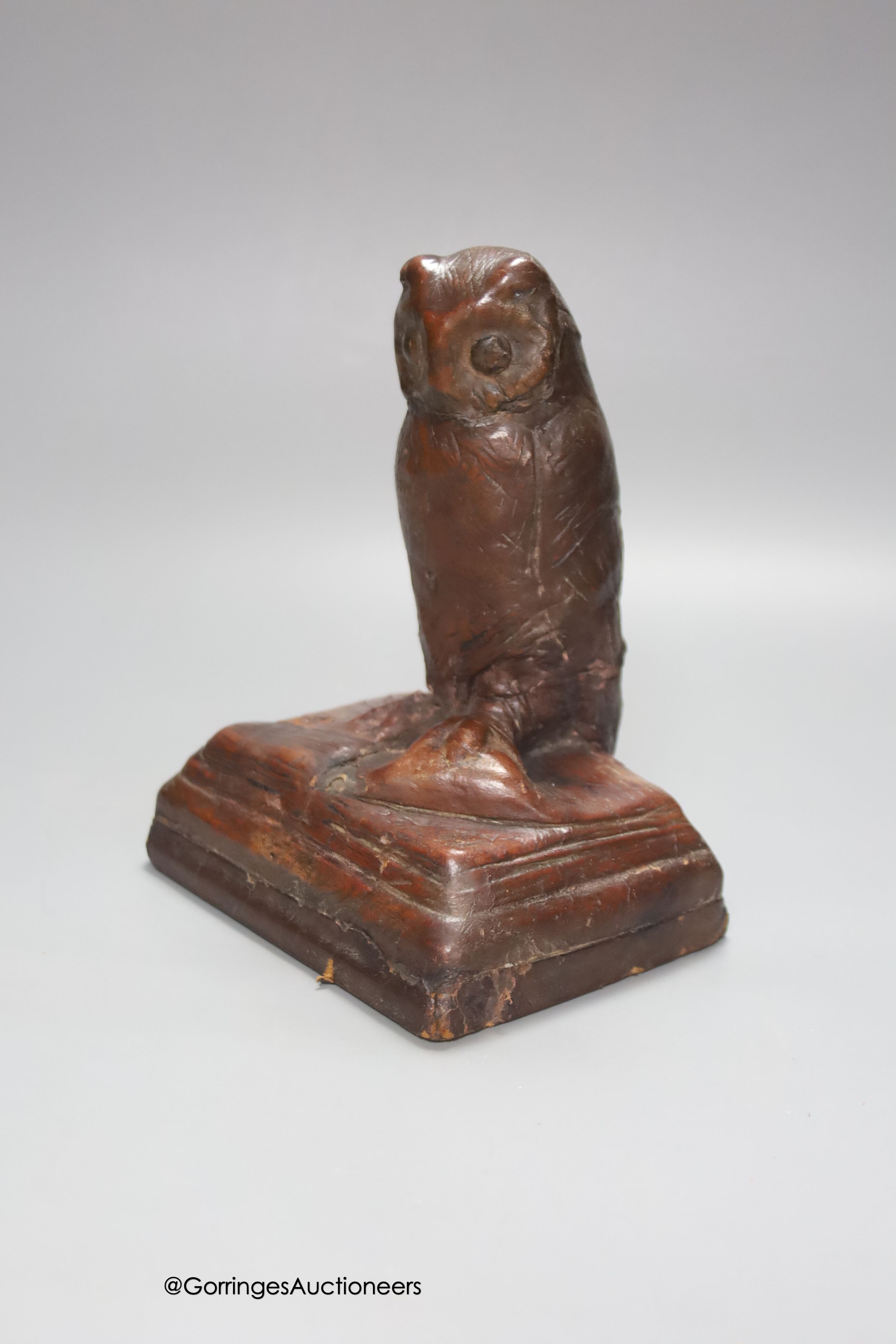 A handmade leather owl, signed H.E. Jackman MC, signed and inscribed underside, height 18cm, repaired